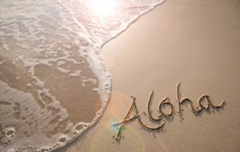 Aloha phrase written in the sand