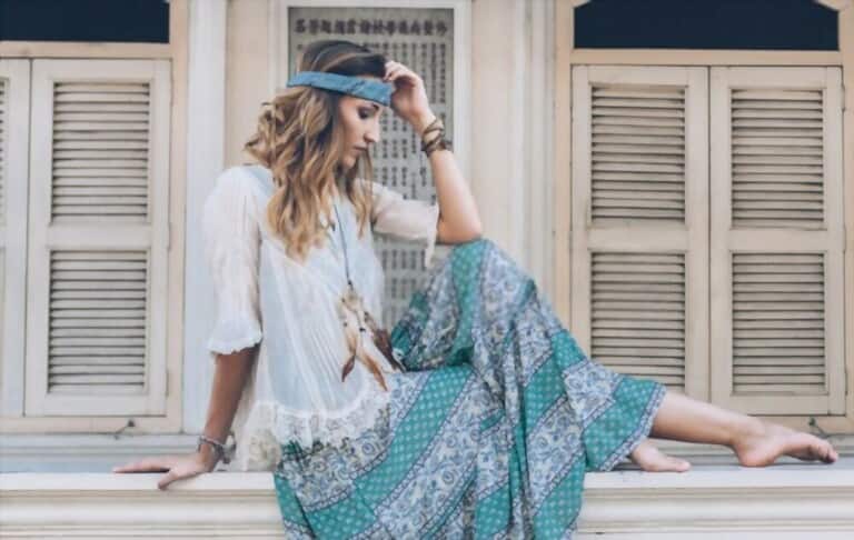 a girl with bohemian style sitting near windows