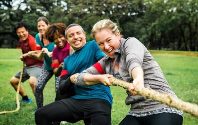 team competing tug war with long, cool clothes team competing tug war with long, cool clothes