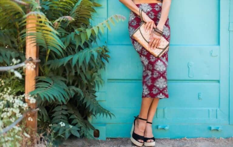 girl wearing tropical pattern dress combined with black high heels leaning on the door girl wearing tropical pattern dress combined with black high heels leaning on the door