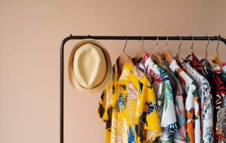 Hawaiian shirts are hung on hanger on a light background