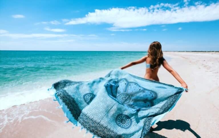 an attractive girl with the sarong-the stylish beach wrap on the beach