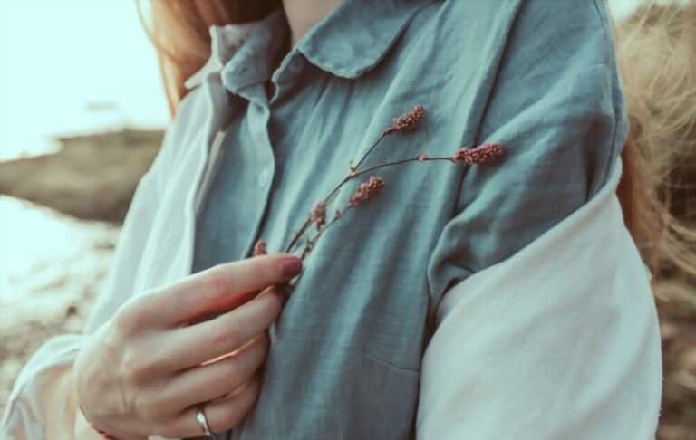 a girl wearing linen shirt holding flowers a girl wearing linen shirt holding flowers