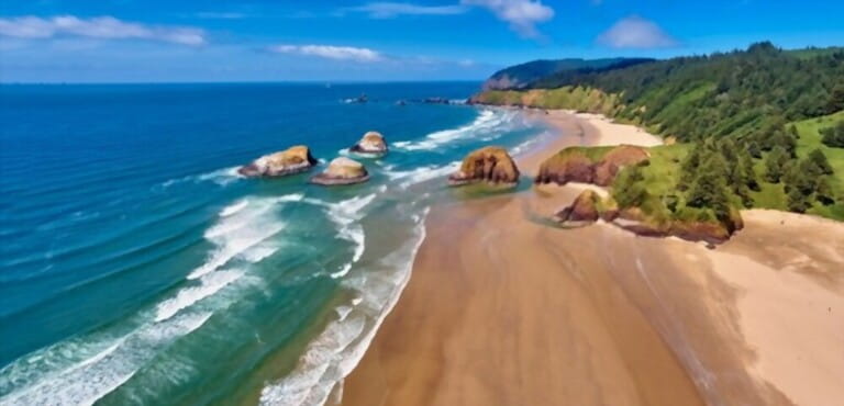 Aerial panorama at about 350 feet above Cannon Beach looking towards Ecola State Park on a sunny day on the Oregon coast Aerial panorama at about 350 feet above Cannon Beach looking towards Ecola State Park on a sunny day on the Oregon coast