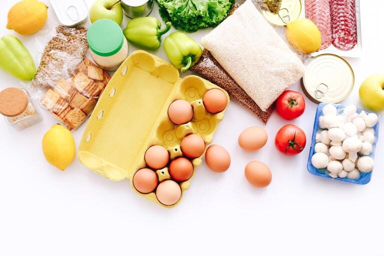 Set of grocery items from canned food, vegetables, cereal on white bacground. Food delivery concept. Donation concept. Top view. Set of grocery items from canned food, vegetables, cereal on white bacground. Food delivery concept. Donation concept. Top view.