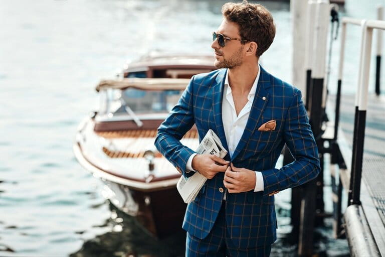Handsome young man in vintage suit on lake background Handsome young man in vintage suit on lake background