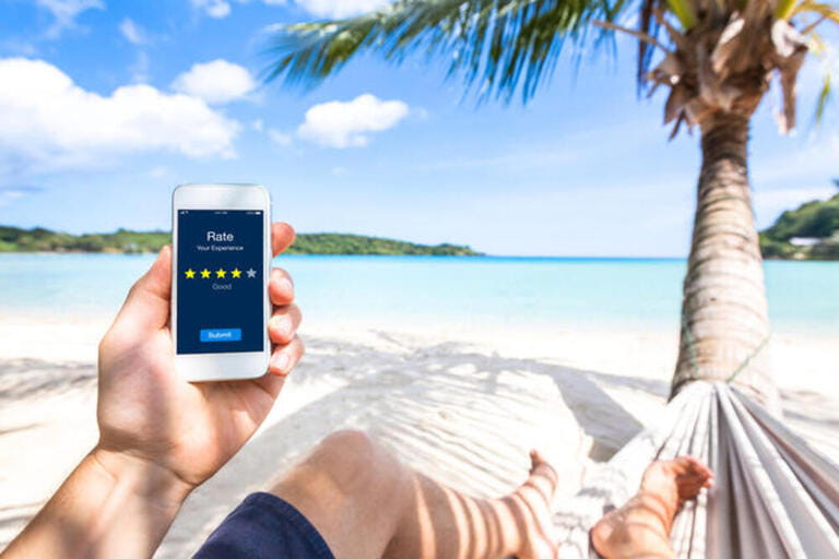 Customer review online app on smartphone screen asking user on the beach to rate experience and give feedback, satisfaction evaluation with star icons