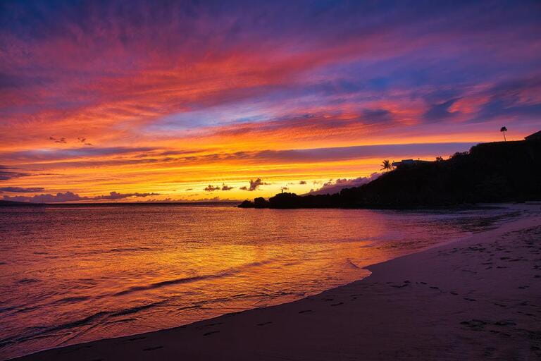 Spectacular blue, pink, and gold sunset on the beach at black rock on Maui. Spectacular blue, pink, and gold sunset on the beach at black rock on Maui.