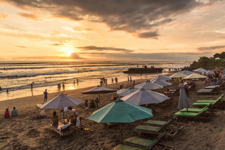 People enjoy the sunset over Canggu beach, north of Kuta and Seminyak, in Bali in Indonesia