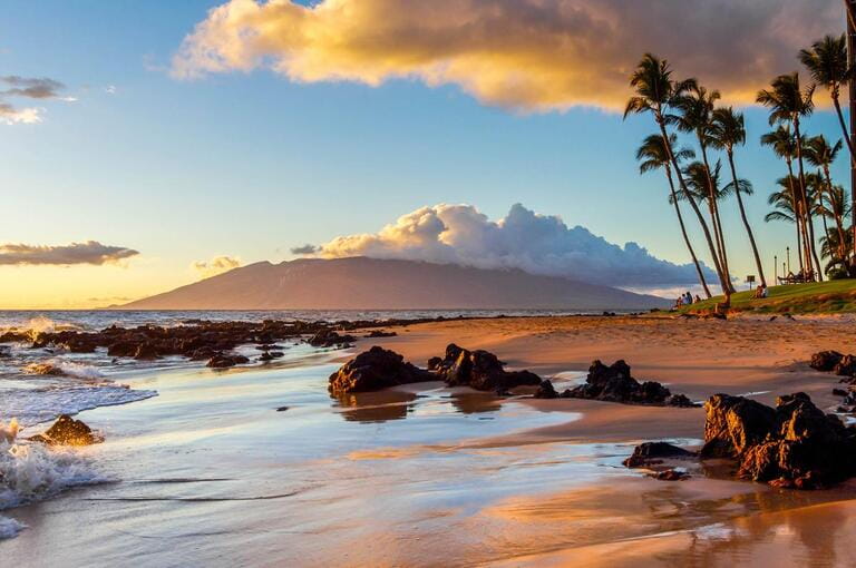 Sunset creates a warm glow on a beach in Maui.