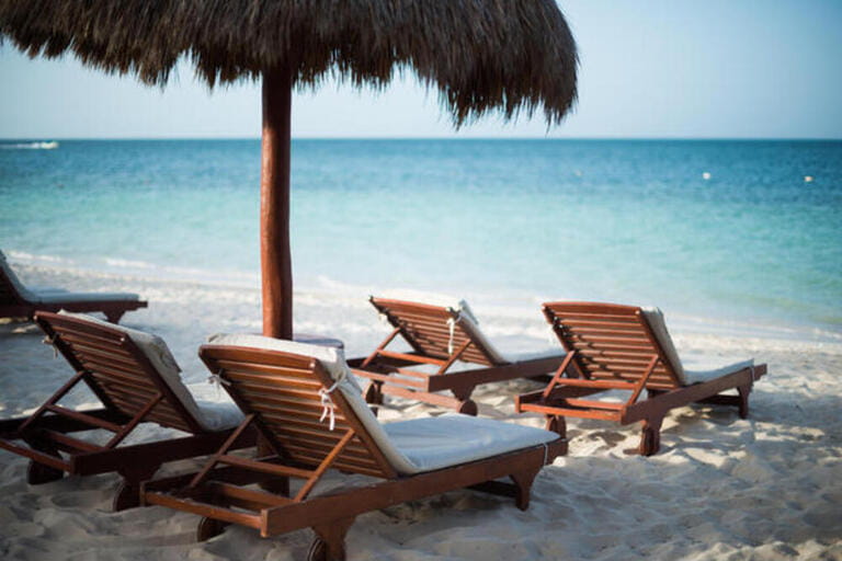 Deck chairs on the beach in at Playa Mujeres in Mexico. Deck chairs on the beach in at Playa Mujeres in Mexico.