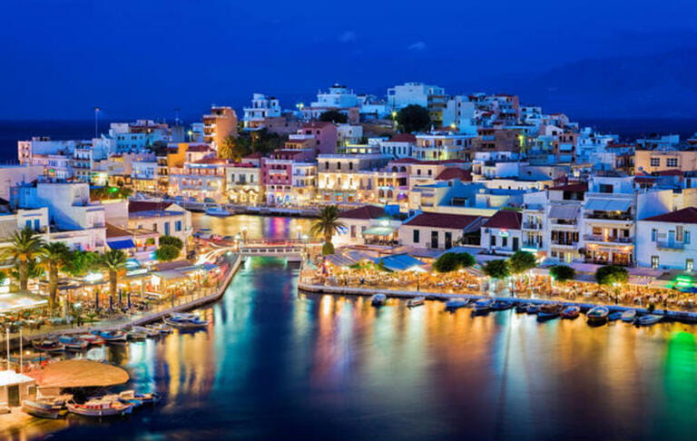 Agios Nikolaos at night. Crete, Greece. Agios Nikolaos is a picturesque town in the eastern part of the island Crete built on th Agios Nikolaos at night. Crete, Greece. Agios Nikolaos is a picturesque town in the eastern part of the island Crete built on th