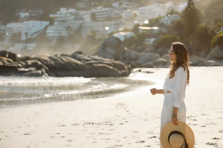 Elegant dreamy girl walking on the beach