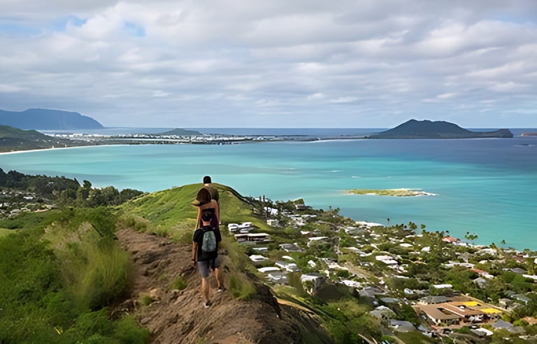 Hikers with the view of Lanikai from a top the Pillbox hiking trail Kailua Hawaii in December Hikers with the view of Lanikai from a top the Pillbox hiking trail Kailua Hawaii in December