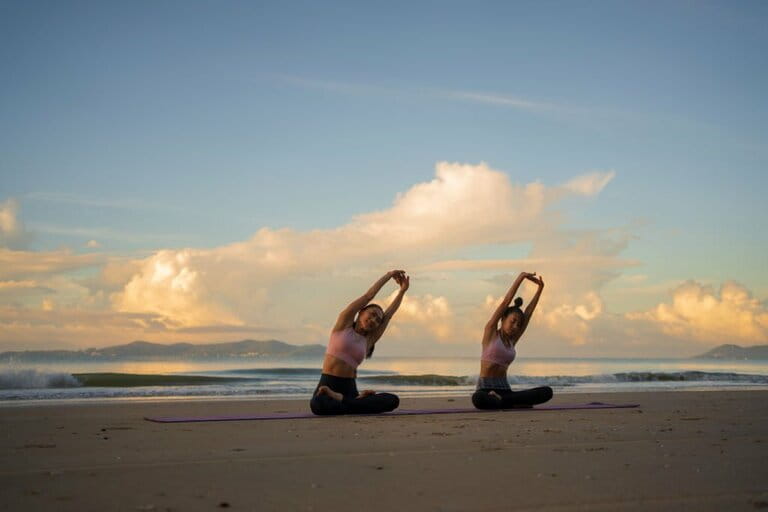 Two Asian woman practicing yoga and sunrise in morning at the beach. Two Asian woman practicing yoga and sunrise in morning at the beach.