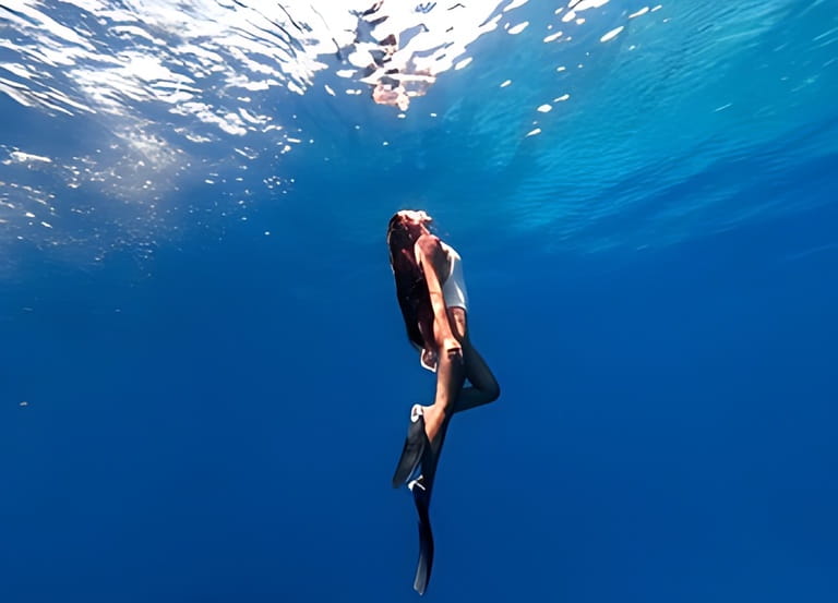 Snorkeling woman exploring beautiful ocean sealife. Water sport outdoor activities. Swimming and snorkeling on summer holidays. Under and above water photography. Snorkeling woman exploring beautiful ocean sealife. Water sport outdoor activities. Swimming and snorkeling on summer holidays. Under and above water photography.