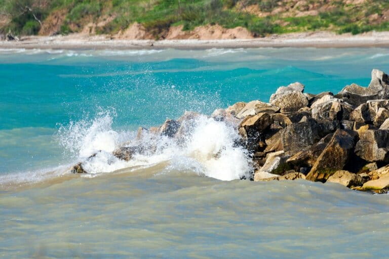 A wave crashes into a broken wall at Coral Dock Park in Port Washington, Wisconsin